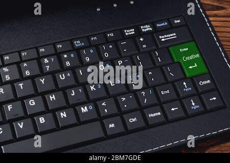 Computer keyboard. The "Creative" keyboard button is green for the network community concept. close-up Stock Photo