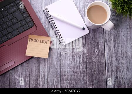 Coffee cup, laptop and notebook with to do list  Stock Photo