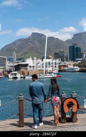 Cape Town, South Africa. 2019. Young couple on the V&A Waterfront holding hands and admiring the view. Stock Photo
