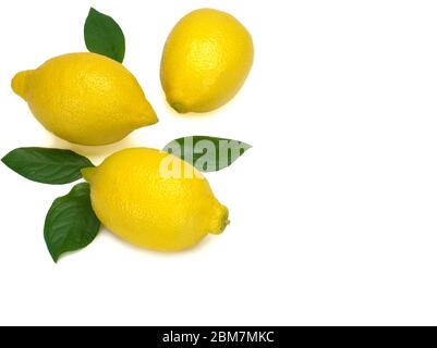 Three whole yellow lemons with green leaves isolated on white background Stock Photo