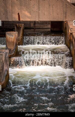 Fish ladder with rapids in fall woodland landscape. Overflow of water ...