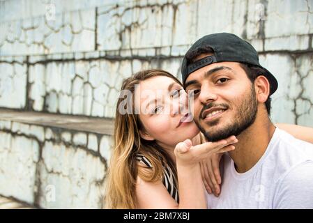A Couple is Sitting closely and talking to each other. Stock Photo