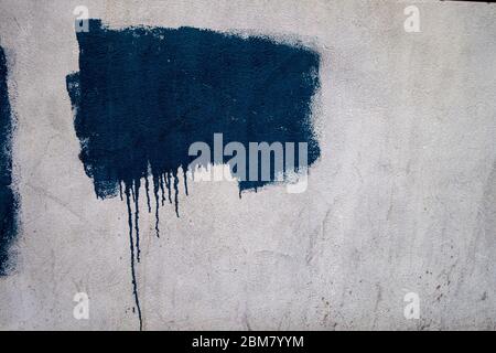 textured painted area on white wall with driipping bottom background; backdrop Stock Photo