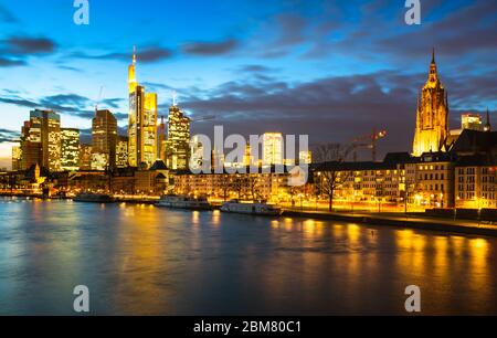 Dusk on the Main with the city in lights, Frankfurt am Main, Hesse, Germany. Stock Photo