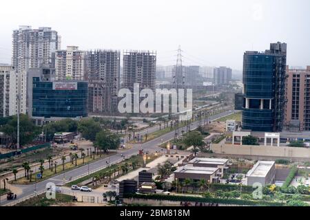 shot showing the empty streets and intersection moving to sky scrapers with resedences, homes, offices and more in the modern city of gurgaon Stock Photo