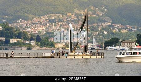 COMO, ITALY - JUNE 2019: Modern sculpture on a jetty which runs out into the harbour of Como on Lake Como. Stock Photo