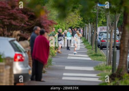 Merton Park, London, UK. 7 May 2020. Residents and neighbours of a leafy south London street clap for NHS and Carers at 8.00pm on a warm evening on day 45 of the Coronavirus lockdown. Credit: Malcolm Park/Alamy Live News. Stock Photo