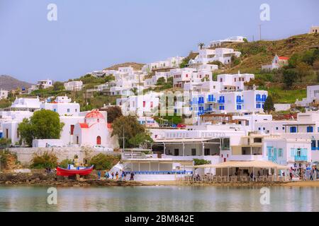 Mykonos, Greece - April 23, 2019: Famous island white houses view from the sea in Cyclades Stock Photo