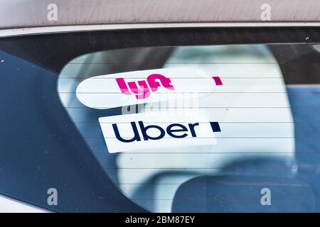 Dec 19, 2019 Redwood City / CA / USA - Lyft and UBER stickers on the rear window of a vehicle offering rides in San Francisco Bay Area Stock Photo