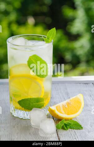 Citrus fresh lemonade in garden setting,summer drink.