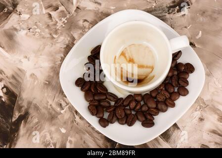 Drawing coffee grounds at the bottom of the cup. Fortune telling on coffee grounds. Roasted coffee beans. Stock Photo