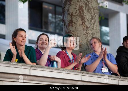 London, UK, 7 May 2020: Staff of the NHS hospital St Thomas' gather on the wall which faces across the river Thames to the Houses of Parliament, where they gave and received applause for their dedicated efforts to treat victims of the COVID-19 pandemic. Anna Watson/Alamy Live News Stock Photo