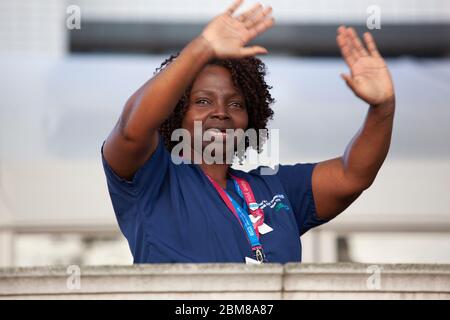 London, UK, 7 May 2020: Staff of the NHS hospital St Thomas' gather on the wall which faces across the river Thames to the Houses of Parliament, where they gave and received applause for their dedicated efforts to treat victims of the COVID-19 pandemic. Anna Watson/Alamy Live News Stock Photo