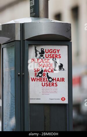 Buggy users please make space for wheelchair users. Sign on bus stop post in London, England. Stock Photo