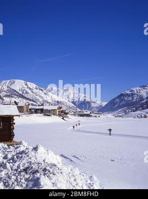 Cross-country skiers on frozen lake, Livigno, Alta Valtellina, Lombardy, Italy Stock Photo