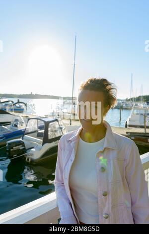 Mature Beautiful Woman Against Scenic View Of The Lake Stock Photo - Alamy