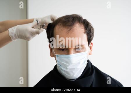 Man Cutting Short Hair At Salon In Face Mask Stock Photo