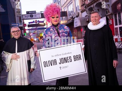 07 May 2020, Hamburg: Olivia Jones (M), drag queen and entrepreneur, Sieghard Wilm (r), pastor of the St. Pauli Church, and Karl Schultz, pastor at the St. Joseph Church, stand in front of the Große Freiheit on the Reeperbahn during a protest action of neighborhood restaurateurs, club and pub owners on Beatles Platz. In the Hamburg cult district of St. Pauli, bar and pub owners drew attention to their existential needs on Thursday evening because of the Corona crisis and demanded more financial aid. The initiator of the protest action on the Reeperbahn was drag queen Olivia Jones, who runs sev Stock Photo