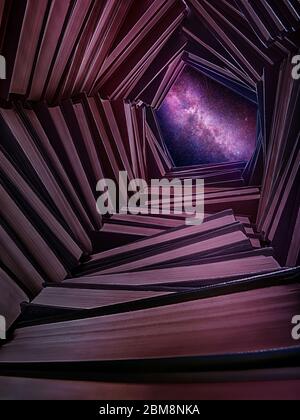 A well made of books with a starry sky above it. View from inside Stock Photo