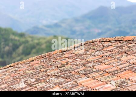 Clay tiles close-up. Old tiles on the houses of Tuscany. The old technology is better than the new ones. Stock Photo