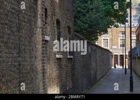 London, UK - 7 May 2020: An alleyway in London with old fashioned black lampposts Stock Photo