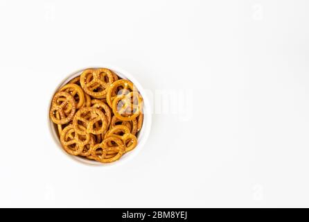 Salted pretzels in a white bowl isolated on a white background with copy space Stock Photo