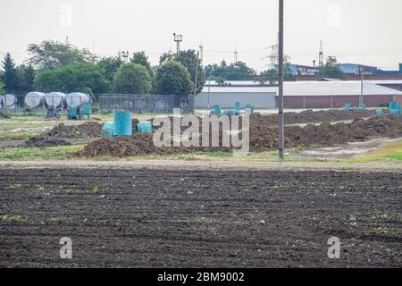 Clay slides are raw materials for a brick factory. Storage of clay for making bricks. Stock Photo