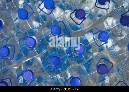 Lot of bottles worth with clean cool natural water. Group of plastic bottles with water stand in a row. Stock Photo