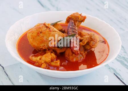 Spicy Reddish Chicken Curry or masala served in a bowl