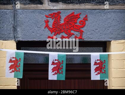 Traditional Welsh Bunting and Red Welsh Dragon on doorway in Penmachno, Penmachno, Snowdonia, North Wales, UK Stock Photo