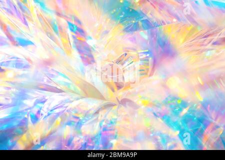 Abstract cheerful fancy festive party background texture of vibrant holographic curly metallic foil ornament with bright shiny crystal gleaming reflec Stock Photo
