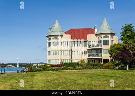 VICTORIA, CANADA - JULY 14, 2019: Modern apartment building facade view with big green lawn. Stock Photo