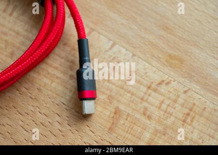 The USB type c is a hi speed data transfer and quick or fast charge battery.It a new connector port of a computer , laptop, or cell phone.A red cable Stock Photo