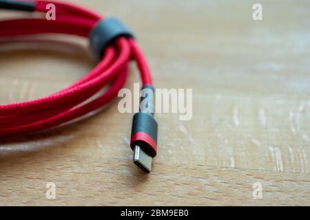 The USB type c is a hi speed data transfer and quick or fast charge battery.It a new connector port of a computer , laptop, or cell phone.A red cable Stock Photo