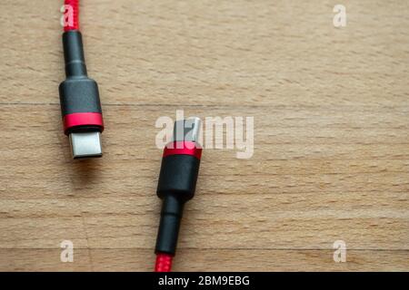 The USB type c is a hi speed data transfer and quick or fast charge battery.It a new connector port of a computer , laptop, or cell phone.A red cable Stock Photo