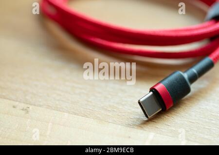 The USB type c is a hi speed data transfer and quick or fast charge battery.It a new connector port of a computer , laptop, or cell phone.A red cable Stock Photo