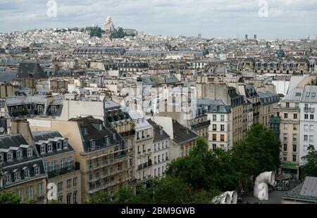 Rooftop view of city of Paris and Basilica of Sacre Coeur church on top of the hill of Montmartre in the background.Paris.France Stock Photo