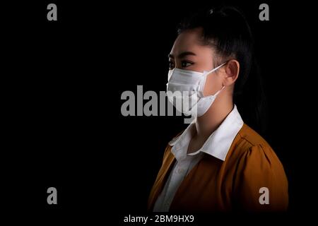 Woman of young Asia woman putting on a face mask to protect from airborne respiratory diseases as the flu covid-19 coronavirus PM2.5 dust and smog, Sa Stock Photo