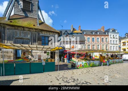 The market outside the Church of Saint Catherine selling fresh produce and groceries in the town of Honfleur France on a sunny day in early autumn Stock Photo