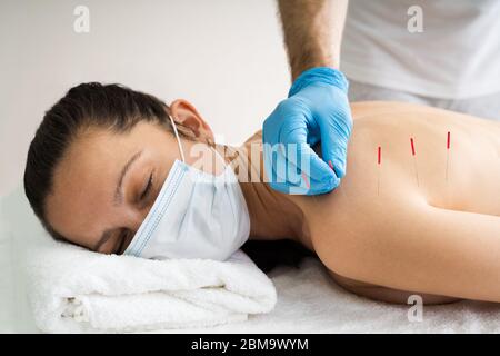 Acupuncture Skin Treatment For Women In Face Mask Stock Photo