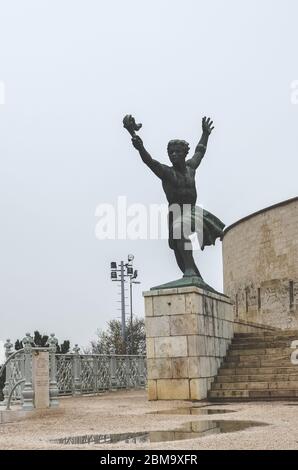 Budapest, Hungary - Nov 6, 2019: Side statue of the Liberty Statue on the Gellert hill. Torchbearer sculpture. Tourist landmarks in the Hungarian capital. Vertical photo. Stock Photo