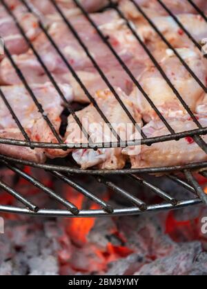 Grilled chicken legs on the flaming barbeque grill. food concept. Stock Photo