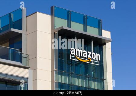 The Amazon logo at Amazon campus in Palo Alto, California. The Palo Alto location hosts A9 Search, Amazon Web Services, and Amazon Game Studios teams. Stock Photo