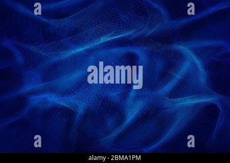Flowing dynamic particles, forming a technological abstract background like silk. Stock Photo