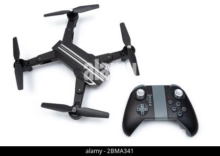 Quadcopter drone with drone remote control on white background. Stock Photo
