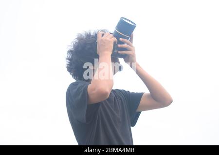 Young photographer taking photos of sky in sunny time. Stock Photo