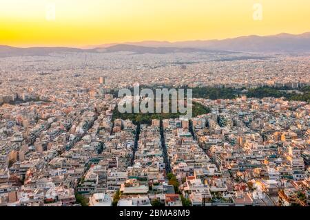 Greece. Warm summer evening over the rooftops of Athens. Residential buildings and narrow streets. Aerial view Stock Photo