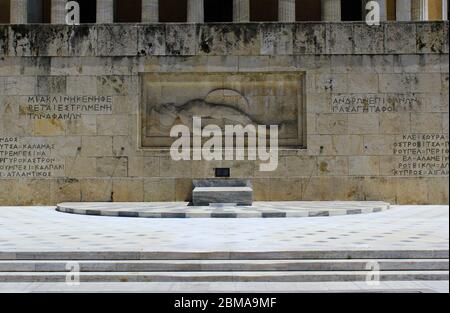 Athens, Greece, May 6 2020 - One of the most touristic spots in Athens - the tomb of the unknown soldier in front of the Greek Parliament with the fam Stock Photo