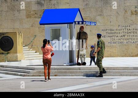 Athens, Greece, May 6 2020 - One of the most touristic spots in Athens - the tomb of the unknown soldier in front of the Greek Parliament with the fam Stock Photo