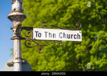 Sign on old street lamp saying  To The Church'. Much Hadham, Hertfordshire. UK Stock Photo